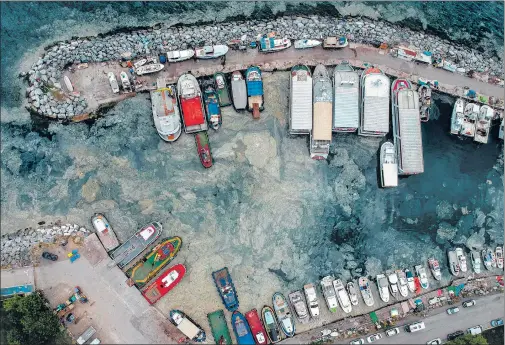  ?? AFP ?? STICKY SEA: Mucilage, a jelly-like fluid that forms on sea water naturally due to microscopi­c plants and is commonly known as ‘sea snot’, is seen in this aerial photo coating a large section of the iconic Marmara Sea’s waters at a harbour in Istanbul, Turkey. First documented in Turkey’s waters back in 2007, the rare natural phenomenon has raised concerns among environmen­talists who have lately been warning that sea snot could be on the rise due to the impact of the climate crisis. Mucilage is known to hamper the ecosystem of marine waters.