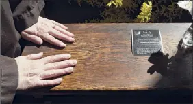  ?? . ?? Sister Teresa Irene Perkins, of the Order of Discalced Carmelites, places her hands on a prayer bench that belonged to The Rev. Mychal Judge.