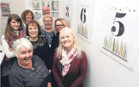  ??  ?? Editor-in-chief Angela Gilchrist, centre, wearing black, and some of the magazine’s staff. Picture: Mhairi Edwards.