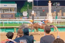  ?? GARY GRAVES/ASSOCIATED PRESS ?? Things are back to normal at Churchill Down with a capacity crowd expected for Saturday’s first Triple Crown race of 2022. Above, fans crowd the rail during a race Saturday.