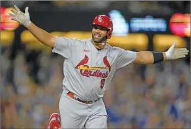  ?? Associated Press ?? COACHING IN PUJOLS’ FUTURE?: St. Louis Cardinals designated hitter Albert Pujols (5) reacts after hitting his 700th home run during the fourth inning of a baseball game against the Los Angeles Dodgers in Los Angeles on Sept. 23, 2022. Pujols said Thursday he believes he will eventually return to baseball as a coach during a stop at St. Louis Cardinals' camp.