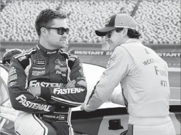  ?? Chuck Burton Associated Press ?? NASCAR driver Ricky Stenhouse Jr., left, chats with 23-year-old colleague Ryan Blaney in May.