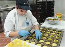  ?? DANA JENSEN/THE DAY ?? Ledyard Schools Transition Academy intern Chelsey Rediger of Ledyard prepares jalapeno cornbread Wednesday in the bakery at Mohegan Sun.