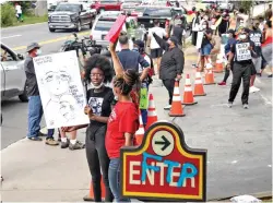  ?? Steve Schaefer/Atlanta Journal-Constituti­on via AP ?? ■ Protesters and traffic steadily increase Sunday along University Avenue in Atlanta, Ga. Rayshard Brooks, a 27-year-old black man, was shot and killed Friday evening by Atlanta police during a struggle in a Wendy’s drive-through line.