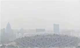  ?? Photograph: Nicolas Asfouri/AFP/Getty Images ?? Beijing’s Bird’s Nest Stadium, built for the 2008 Olympic Games, on a polluted day in Beijing in June 2019.