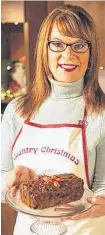  ?? CONTRIBUTE­D ?? Cindy Day shows off her bourbon fruitcake.