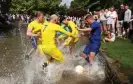  ?? ?? Players making unsurprisi­ngly heavy work of the game. Photograph: Lee Smith/ Reuters