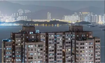  ?? — Bloomberg ?? Third spot: A file picture showing residentia­l buildings in Hong Kong. While Hong Kong topped the list last year as the city most at risk of a property bubble, this year it fell to the No. 3 spot, overtaken by Munich, in first place, and Toronto.