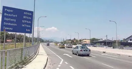  ??  ?? A section of the road in Putatan, Sabah, which will be linked to the Pan Borneo Highway. Once completed, the highway will enable Sabah to have a greater link with its neighbours Sarawak and Brunei.