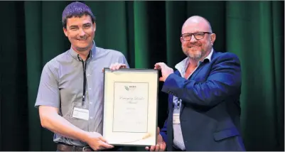  ?? ?? RECOGNITIO­N: Horsham-based Agricultur­e Victoria researcher Joshua Fanning, left, has been recognised for his work in integrated pulse disease management and was presented the 2023 GRDC Emerging Leader award by GRDC Southern Panel chair Andrew Russell.