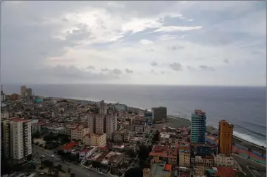  ?? Associated Press ?? This coastal view Sunday of Havana shows the United States Interests Section diplomatic mission, the third tall building from the right. On Friday, the Obama administra­tion formally removed Cuba from a U.S. terrorism blacklist as part of the process of...