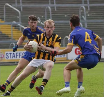  ??  ?? Simon Donohoe of Shelmalier­s is tracked by Mark O’Neill and Jack O’Connor of Gusserane.