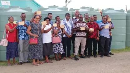  ?? Director Mr Iliapi Tuwai, ?? Minister for Agricultur­e, Waterways and Environmen­t Hon. Dr. Mahendra Reddy with ADRA Fiji Country Ministry staff and the recipients of the water tanks.