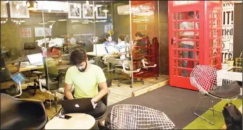  ??  ?? In this file photo, an Indian entreprene­ur works on his laptop at Innov8, a lax co-working space in New Delhi, India. As India emerges as one of the biggest markets in the world for tech-based startups, workspaces are transformi­ng from traditiona­l and...