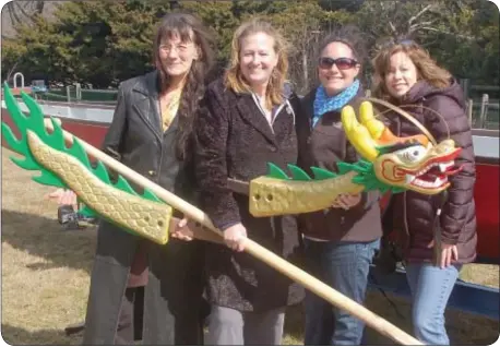  ??  ?? Showing off the head and tail of their new dragon boat are, from left, Laura Kent, Laurie McHugh, Jacquelyn Wetzel and Cindy Taylor.