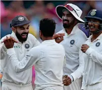  ??  ?? India’s Virhat Kohli (left) celebrates with Kuldeep Yadav after the dismissal of Australia’s Travis Head. —