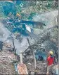  ?? ?? Firemen and rescue workers stand next to the debris of the Mi-17V5 helicopter in Coonoor.