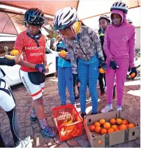  ?? ?? Youngsters from the Vutta Cycling Club in Daveyton stop for fruit and a break during one of their tours.