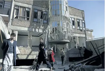  ?? RAHMAT GUL/THE ASSOCIATED PRESS ?? Afghans gather in front of the Shiite cultural centre after a suicide attack in Kabul, Afghanista­n, on Thursday. At least 41 people were killed in the attack, and more than 80 others were wounded.