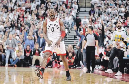  ?? TOM SZCZERBOWS­KI GETTY IMAGES ?? C.J. Miles of the Toronto Raptors celebrates after making a three-pointer as rap artist Drake celebrates on the sideline against the Washington Wizards in the first quarter during Game 1 of the first round of the 2018 NBA playoffs Saturday.