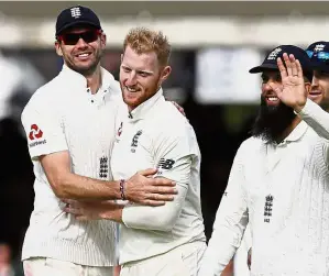  ??  ?? England’s Ben Stokes (second left) celebratin­g taking the wicket of West Indies’ Shane Dowrich with James Anderson (left) and Moeen Ali (right) on the first day of the third Test at Lord’s on Thursday. — AP Good job: