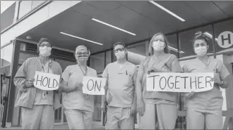 ?? Brad Bogdan Media ?? Health-care workers are seen in this frame from a music video “Hold on Together” performed by local artists Mandy Hubbard and James Oldenburg.