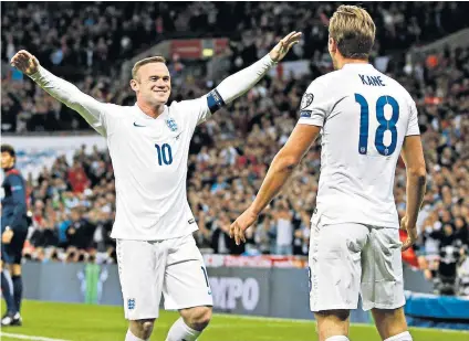  ??  ?? Old pals’ act: Wayne Rooney celebrates with Harry Kane after the Spurs striker’s goal against Switzerlan­d in 2015