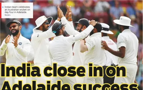  ?? Reuters ?? Indian team celebrates an Australian wicket on day four in Adelaide.