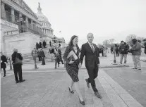  ?? STEVE EARLEY PHOTOS/STAFF FILE ?? Elaine Luria and her husband Robert Blondin walk outside the Capitol after she was sworn in to Congress in Washington in 2019.