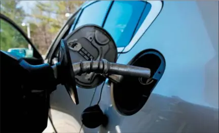  ?? CHARLES KRUPA — THE ASSOCIATED PRESS ?? A car is filled with gasoline at a station in Windham, N.H. Crude oil prices are at the highest level in more than three years and expected to climb higher, pushing up gasoline prices along the way.