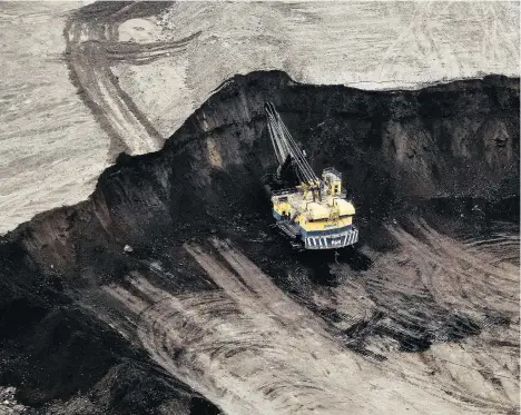  ?? BEN NELMS/BLOOMBERG FILES ?? A machine works at the Suncor mine at the Athabasca oilsands near Fort McMurray, Alta. Some experts believe the pickup in oil prices won’t be enough to offset the Bank of Canada’s concerns, mainly about NAFTA talks and large levels of household debt.