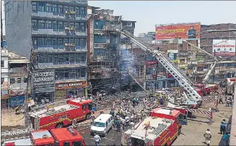  ?? PTI ?? Firefighte­rs douse the fire, which broke out in a hotel near the Patna Junction railway station.