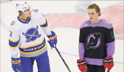  ?? Rich Grassle / Icon Sportswire via Getty Images ?? The Devils’ Tyce Thompson, right, poses for photos with his brother, Sabres winger Tage Thompson, before Tyce’s fist NHL game on Tuesday at the Prudential Center in Newark, NJ.