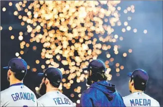  ??  ?? KERSHAW, in jacket, stands with teammates before Game 3 of the World Series. Kershaw won Game 1, couldn’t hold a big lead in Game 5, then pitched four fruitless, scoreless innings in Game 7.