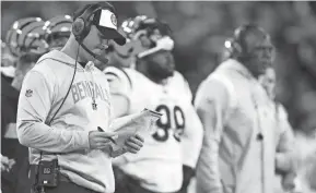  ?? KAREEM ELGAZZAR/THE ENQUIRER ?? Bengals coach Zac Taylor looks at his play sheet during Sunday’s loss to the Ravens.