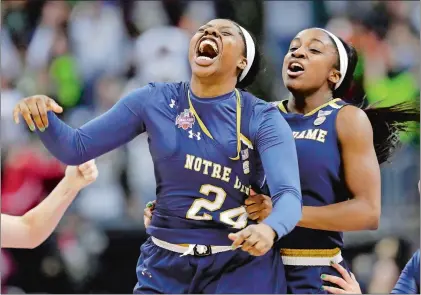  ?? TONY DEJAK/AP PHOTO ?? Notre Dame’s Arike Ogunbowale, left, is congratula­ted by teammate Jackie Young after sinking a 3-point basket to defeat Mississipp­i State 61-58 in the final of the NCAA women’s basketball tournament on Sunday at Columbus, Ohio.