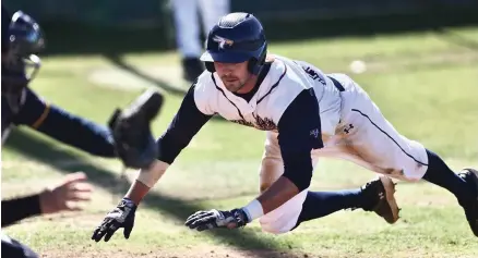  ?? (Photo by JD for the Texarkana Gazette) ?? Texas A&M-Texarkana’s Luke Hyzdu dives in the air at home plate during Tuesday afternoon’s game against Texas Wesleyan in Texarkana, Texas.