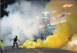  ?? REUTERS ?? Police lob tear gas to disperse demonstrat­ors after a Trump rally in Phoenix on Tuesday.