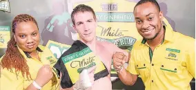  ??  ?? Livingston Scott/Gleaner Writer Wray & Nephew’s Marketing Manager, Nadia Kiffin-Green (left) and Pavel Smith (right), brand manager Wray & Nephew White Overproof Rum, Charley’s J.B. Overproof Rum and Skyy Vodka, congratula­te Canadian boxer, Dave...