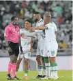  ?? BackpagePi­x ?? MATCH referee Cedrick Muvhali is questioned by AmaZulu players during their recent clash against Orlando Pirates. |