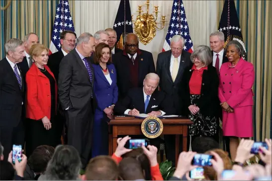  ?? SUSAN WALSH — THE ASSOCIATED PRESS ?? The author contends that lawmakers over age 80 should step down from their posts. Here, President Joe Biden signs the Postal Service Reform Act of 2022 at the White House. Watching from left are Rep. Stephen Lynch, D-Mass., Sen. Tom Carper, D-Del., Rep. Carolyn Maloney, D-N.Y., Sen. Gary Peters, D-Mich., Senate Majority Leader Chuck Schumer of N.Y., Sen. Rob Portman, R-Ohio, House Speaker Nancy Pelosi of Calif., Rep. James Clyburn, D-S.C., Rep. Steny Hoyer, D-Md., Annette Taylor, Rep. James Comer, R-Ky., and Rep. Brenda Lawrence, D-Mich.
