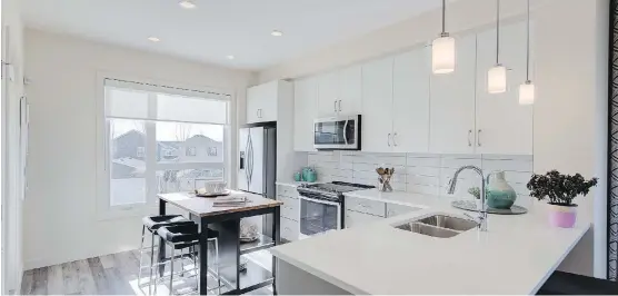  ??  ?? The kitchen in the Rosewood 18.o at the Loop in Evanston by Streetside Developmen­ts. Windows are plentiful in the home’s design, providing ample natural light.