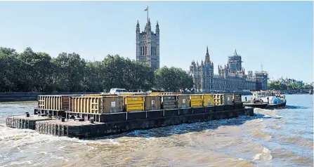  ?? PHOTO SUPPLIED ?? A Cory tug and barges passing the Houses of Parliament.