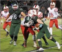  ??  ?? Shenendeho­wa junior running back Griffin Wallner looks to get past Guilderlan­d defensive end Dylan Olson in the first half Friday night at Brent T. Steuerwald Stadium in Clifton Park.