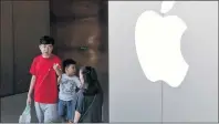  ?? ANDY WONG/THE ASSOCIATED PRESS ?? In this July 30 file photo, a Chinese family walks out of an Apple store in Beijing.