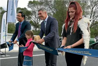  ?? PHOTO: JOEL MAXWELL/FAIRFAX NZ ?? Snipping the ribbon on the first section of the Kapiti Expressway is Transport Minister Simon Bridges, Te Ati Awa iwi member Grace Ahern, 6, Otaki MP Nathan Guy, and iwi member Ruby-Mei Franklyn.