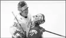  ?? Canadian Press via AP ?? Canada goaltender Ann-Renee Desbiens (35) shakes hands with United States goaltender Aerin Frankel (31) following the US’s overtime win at the IIHF Women’s World Hockey Championsh­ip, Monday, in Utica, N.Y.