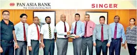  ??  ?? Nalaka Wijayaward­ana – DGM Marketing & Personal banking of Pan Asia Bank and Janaka Mendis – Credit Director of Singer (Sri Lanka) PLC exchanging agreements
