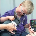  ??  ?? Pupils from White Ash Primary School, Oswaldtwis­tle, meet the animals at Mrs Dowson’s Farm as part of the Rotary ‘Kids Day Out’