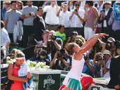  ?? Associated Press photo ?? Latvia's Jelena Ostapenko throws her towel to the public after defeating Timea Bacsinszky, left, of Switzerlan­d during their semifinal match of the French Open tennis tournament at the Roland Garros stadium, Thursday in Paris.